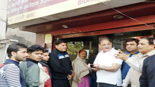 Speaker Legislative Assembly Kavinder Gupta during visit to a bank on Tuesday.