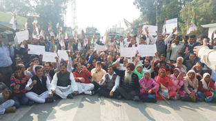 NPP activists staging protest on road near DC office in Udhampur on Tuesday.