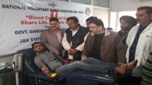 Volunteers donating blood during a camp at Govt Hospital Gandhi Nagar on Sunday.