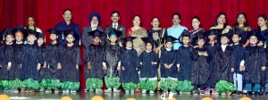 Children in colourful attires posing for a group photograph alongwith chief guest while celebrating Annual Day of Sanfort Preschools at Auditorium of GCW Gandhi Nagar.