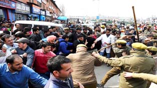 Agitating NHM employees being lathi charged in Srinagar on Monday.