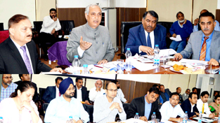 Minister for Revenue A R Veeri chairing a meeting in Jammu on Monday.