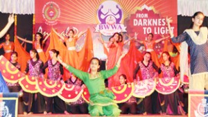 Students in colourful attires presenting dance item while celebrating Annual Day at BSF School in Jammu.