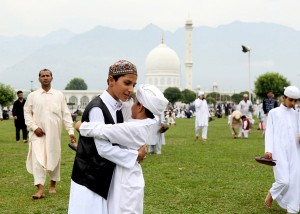 Children hugging each other after Eid prayers at Hazratbal in Srinagar on Monday. -Excelsior/Shakeel