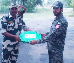 BSF and Rangers exchange sweets on Eid festival at International Border in Jammu sector on Monday.