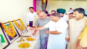 BJP leaders lighting lamp during party programme at Samba on Friday.