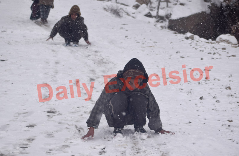 Children enjoying snowfall in Srinagar.    —Excelsior/Shakeel